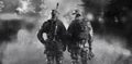 Two soldiers of a special unit are standing in a smoky forest. Royalty Free Stock Photo