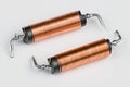 Two solenoids with helical copper wire wound on black coil on white background Royalty Free Stock Photo