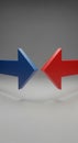 Two solid-colored 3D arrows are positioned to point towards each other. The arrow on the left is Royalty Free Stock Photo