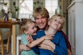 Two sons kissing father's cheeks. Concept of Father's Day, and fatherly love. Real family, real people. Royalty Free Stock Photo