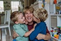 Two sons kissing father's cheeks. Concept of Father's Day, and fatherly love. Real family, real people.