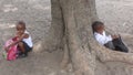 Two South African schoolchildren from a primary school near Santa Lucia wait for the school bus after class