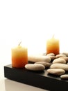 Two spa candles with white stones