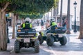 Two Spanish local policeman on quad bike motorcycles on tourist street. MARBELLA, MALAGA/SPAIN - JULY 21 2022