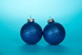 Two sparkling Christmas ball on light blue Royalty Free Stock Photo