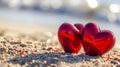 Two sparkling red hearts on a sandy beach, romantic getaway . Valentine\'s day on the beach. Romantic beach scene with red