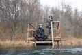 Two spearfishing men standing and sitting on pontoon