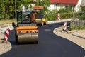 Two special autos paving new asphalt driving in line one near another