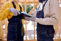 Two Specialists Inspect Wooden House Building Construction Site Documentation Royalty Free Stock Photo