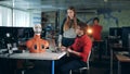 Two specialists are manipulating movements of robot`s face remotely