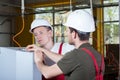 Two specialists repairing factory machine Royalty Free Stock Photo