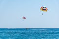 Two speed boats with people flying on parasailing parachute RHO Royalty Free Stock Photo