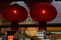 Two sphere shape Chinese red paper lanterns with red tassels. Traditional Chinese Lunar New Year decorations in night darkness. Royalty Free Stock Photo