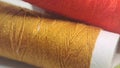 two spools of thread with orange and yellow colors Royalty Free Stock Photo