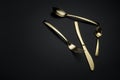 Two spoons, knife and fork on dark background Royalty Free Stock Photo