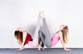 Two sports girls train yoga in a fitness class. Pair of young women stretching