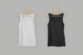 Two sports tanks mockup holding on hanger. White and black tank top isolated