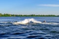 Two sportsmen have fun on jet skis on the Dnieper River in Kherson Ukraine. Men on PWCs put on a show on the blue water surface