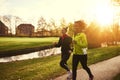 Two sportswomen running in park