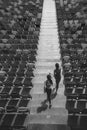 Two sportswomen running on stadium stairs