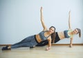 Two sporty girls doing exercises ups in gym Royalty Free Stock Photo