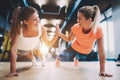 Two sporty girls doing push ups in gym Royalty Free Stock Photo