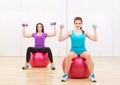 Two sporty girls at fitness club Royalty Free Stock Photo