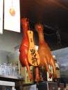 Two squeaky toy chicken hanging from the top of the bar