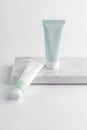 Two squeeze tubes on marble background. Face or hand cream set on marble tray. Cosmetic Tube Blank Mockup.. Royalty Free Stock Photo