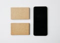 Two stack of craft business cards and smartphone on white background. Horizontal