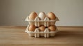 Two stacked egg cartons with brown and one white egg on table. Royalty Free Stock Photo