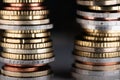 Two stacked Euro coin towers next to each other with dark Background Royalty Free Stock Photo