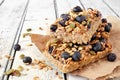 Two stacked superfood breakfast bars, on rustic white wood