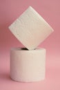 Two stacked toilet paper and pink background Royalty Free Stock Photo