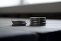 Two stacks of coins on a wooden table. Coins side macro shooting. Money on the table. iron denbgi lie in a stack. Royalty Free Stock Photo