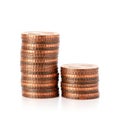 Two stacks of copper coins are displayed on a white background. The taller stack Royalty Free Stock Photo