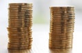 Two stacks of gold money coins coin in pile on blurred background Royalty Free Stock Photo