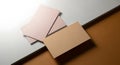 Two stacks of pastel pink and beige rectangular cards on a white and brown background Royalty Free Stock Photo