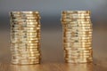 Two stacks of gold money coins coin in pile on blurred background Royalty Free Stock Photo