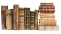 Two stacks of vintage hardcover books with ornate spines, isolated on a white background Royalty Free Stock Photo