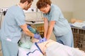 Two staff practicing CPR on mannequin Royalty Free Stock Photo
