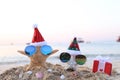 Two starfish on sea beach with sunglasses and santa hat for Merry Christmas and New Years Royalty Free Stock Photo