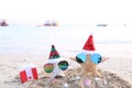 Two starfish on sea beach with sunglasses and santa hat for Merry Christmas and New Years Royalty Free Stock Photo