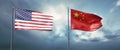 Two state flags of the united states of america and china, facing each other and moving in the wind in front of cl
