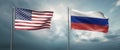 Two state flags of the united states of america and russian federation, facing each other and moving in the wind i