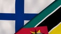 The flags of Finland and Mozambique. News, reportage, business background. 3d illustration