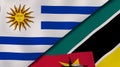 The flags of Uruguay and Mozambique. News, reportage, business background. 3d illustration