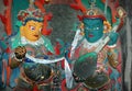 Two statues of Tibetan gods with a musical instrument