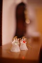 Two statuettes of small angels on the mantelpiece