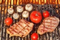 Two Steaks and Vegetables Char-Grilled Over Flaming BBQ Grill